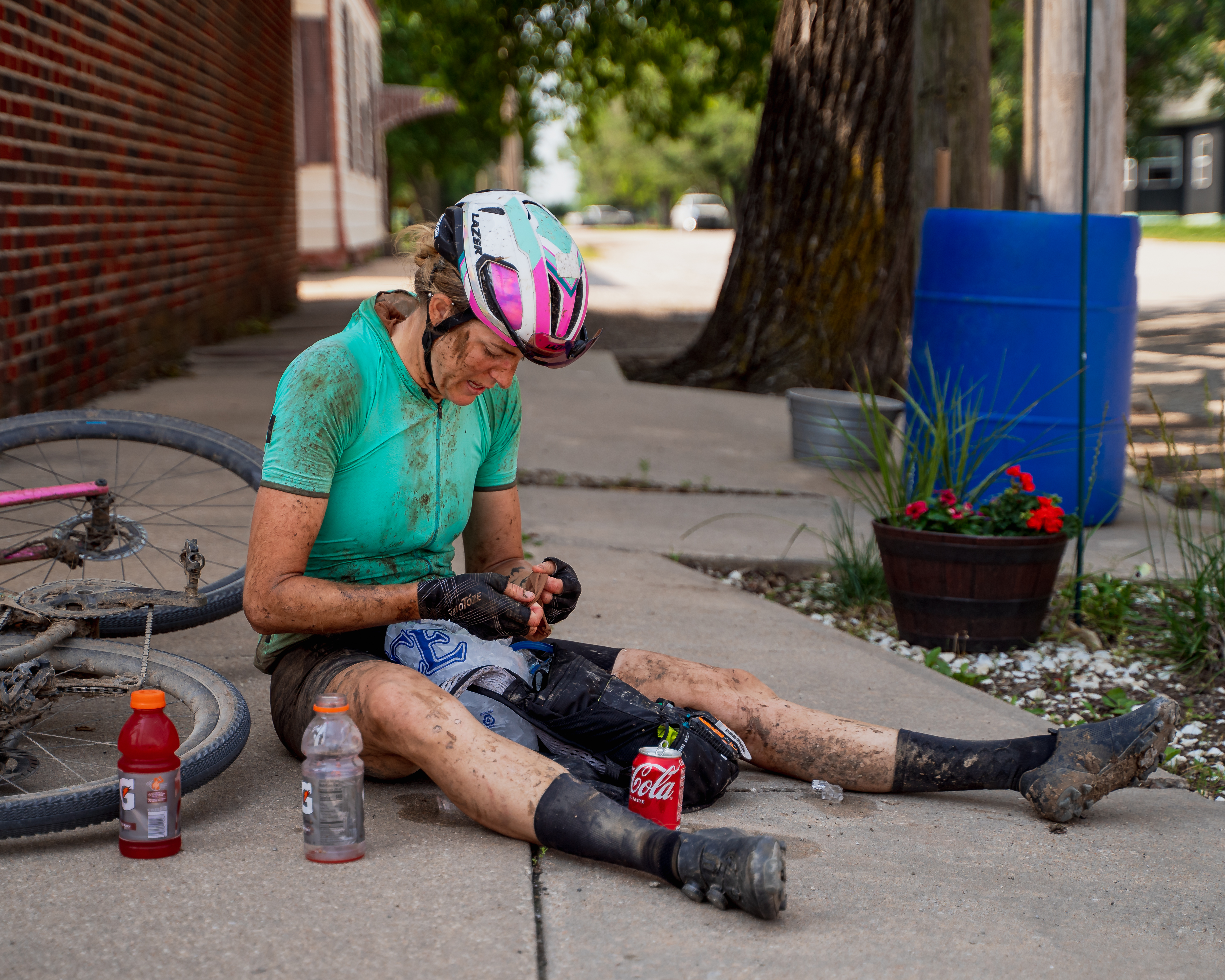 Shimano athlete Kristen Legan sitting enjoying snacks during the Unbound XL gravel bike race