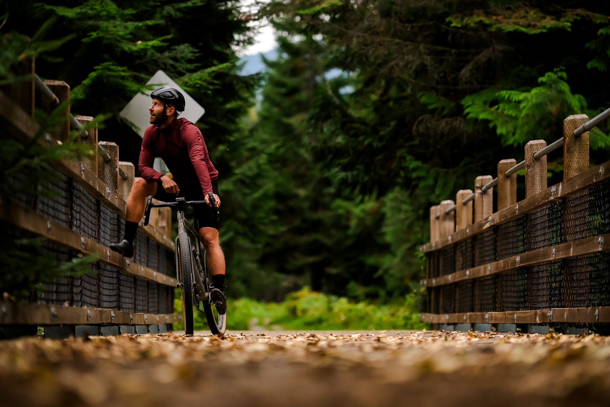 Svein Tuft Pro Road Cyclist riding his gravel bike across a bridge in Canada 
