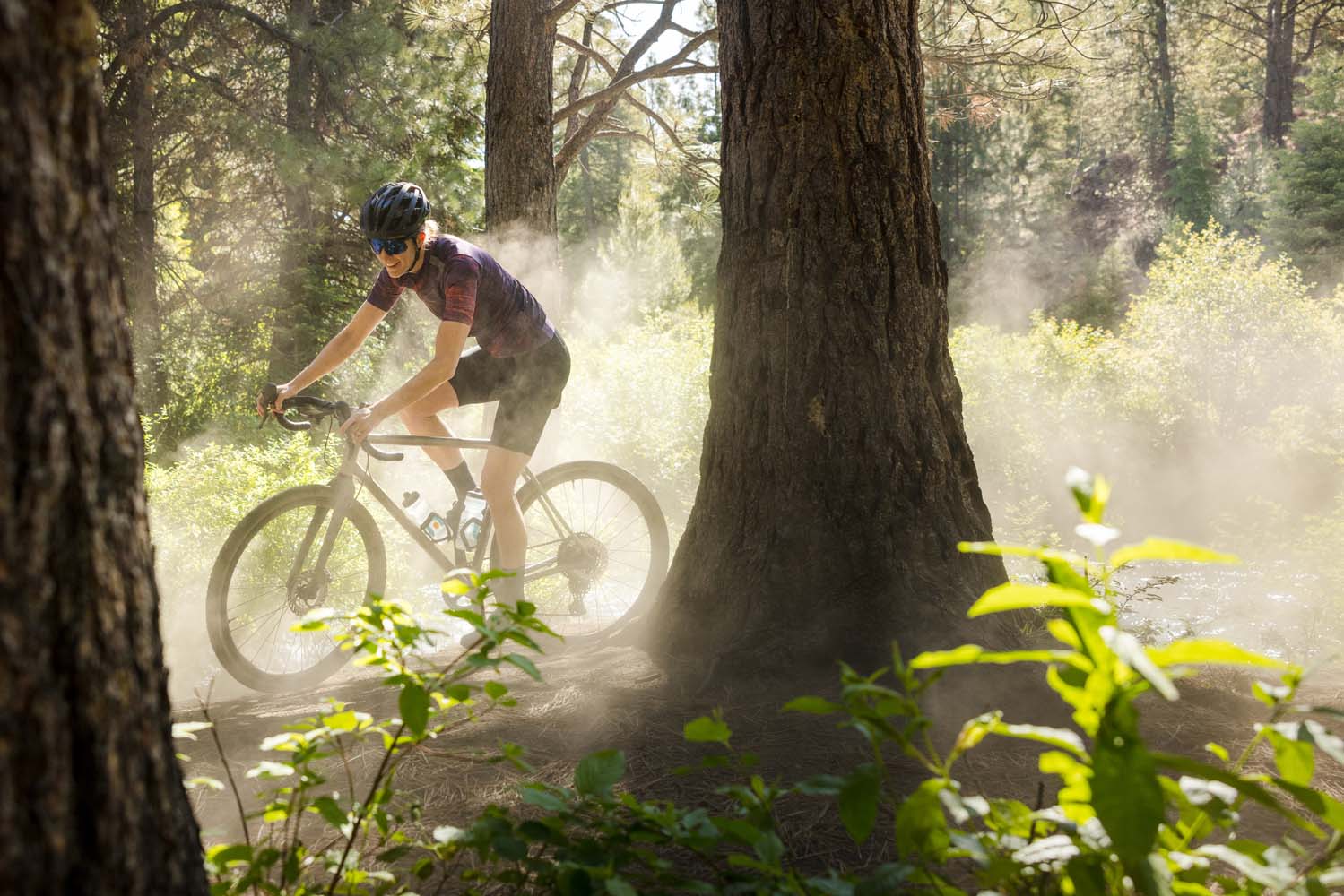 Women riding a Shimano equipped GRX gravel bike down a dusty road 