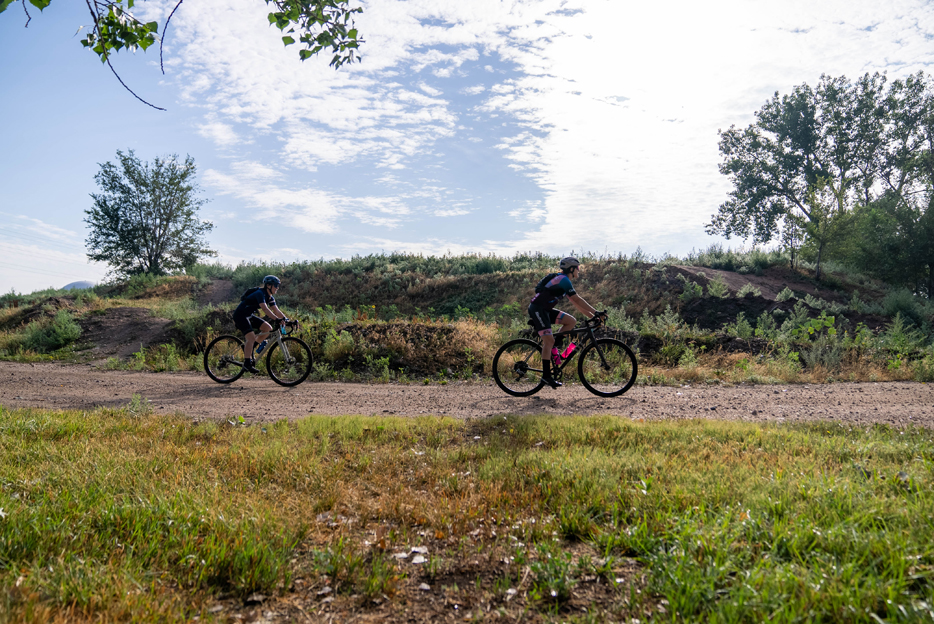 whitney and Zac Allsion riding thier Shimano equipped gravel bikes on a dirt road