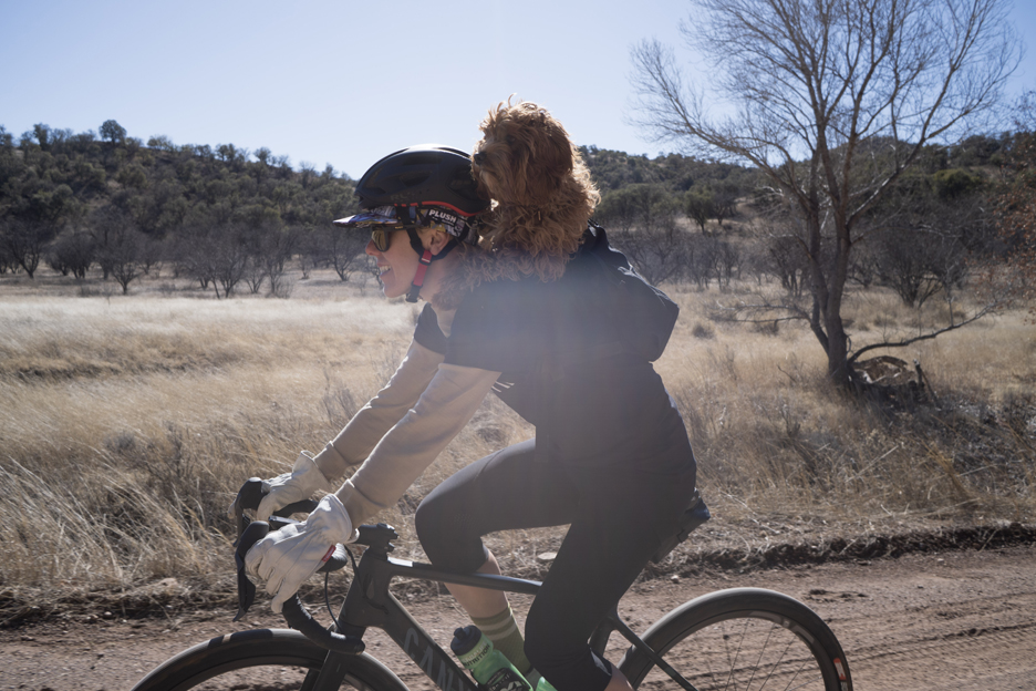 Heather Jackson riding gravel with her dog